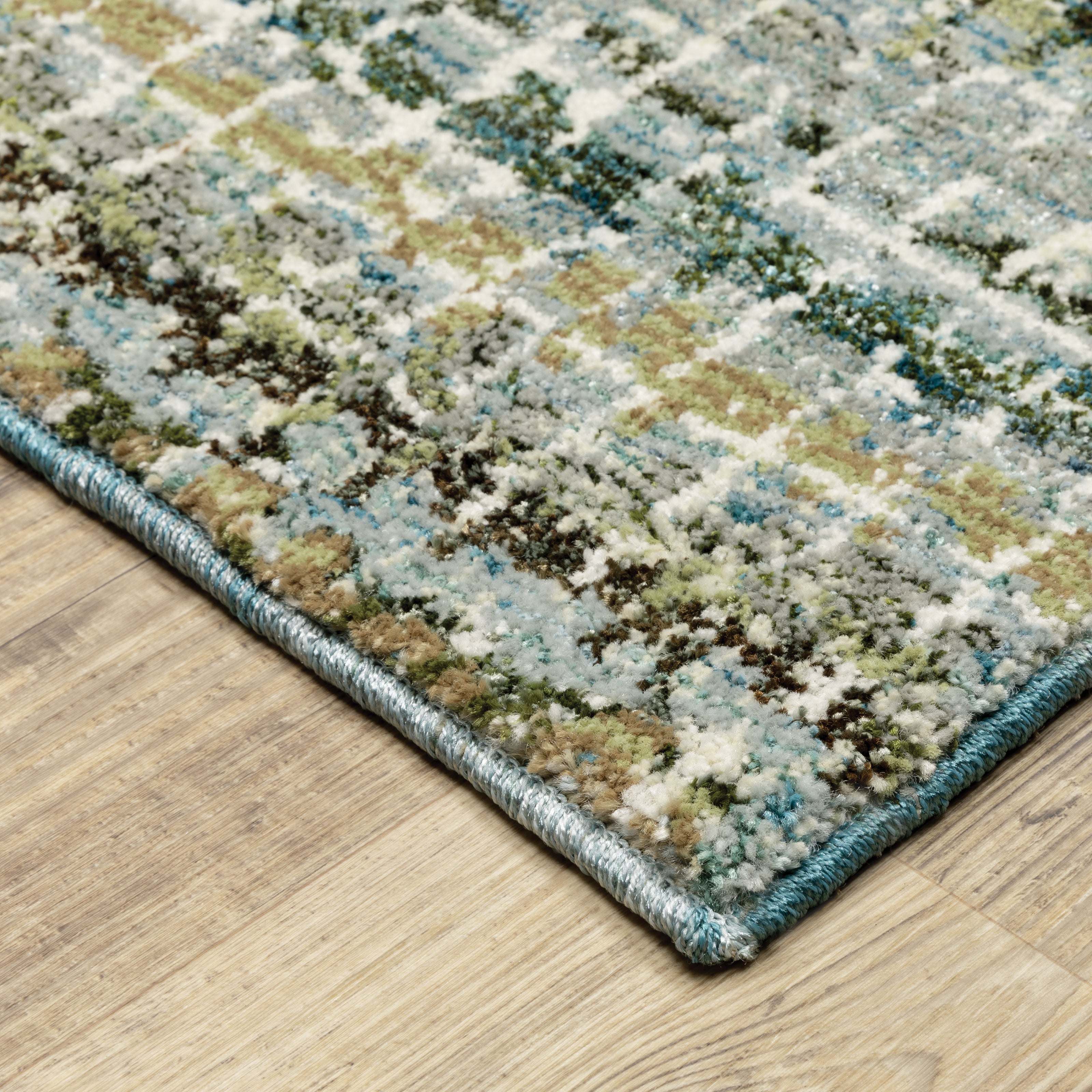 Oriental Weavers Atlas 747B0 textured area rug featuring textured design in blue/ green tones