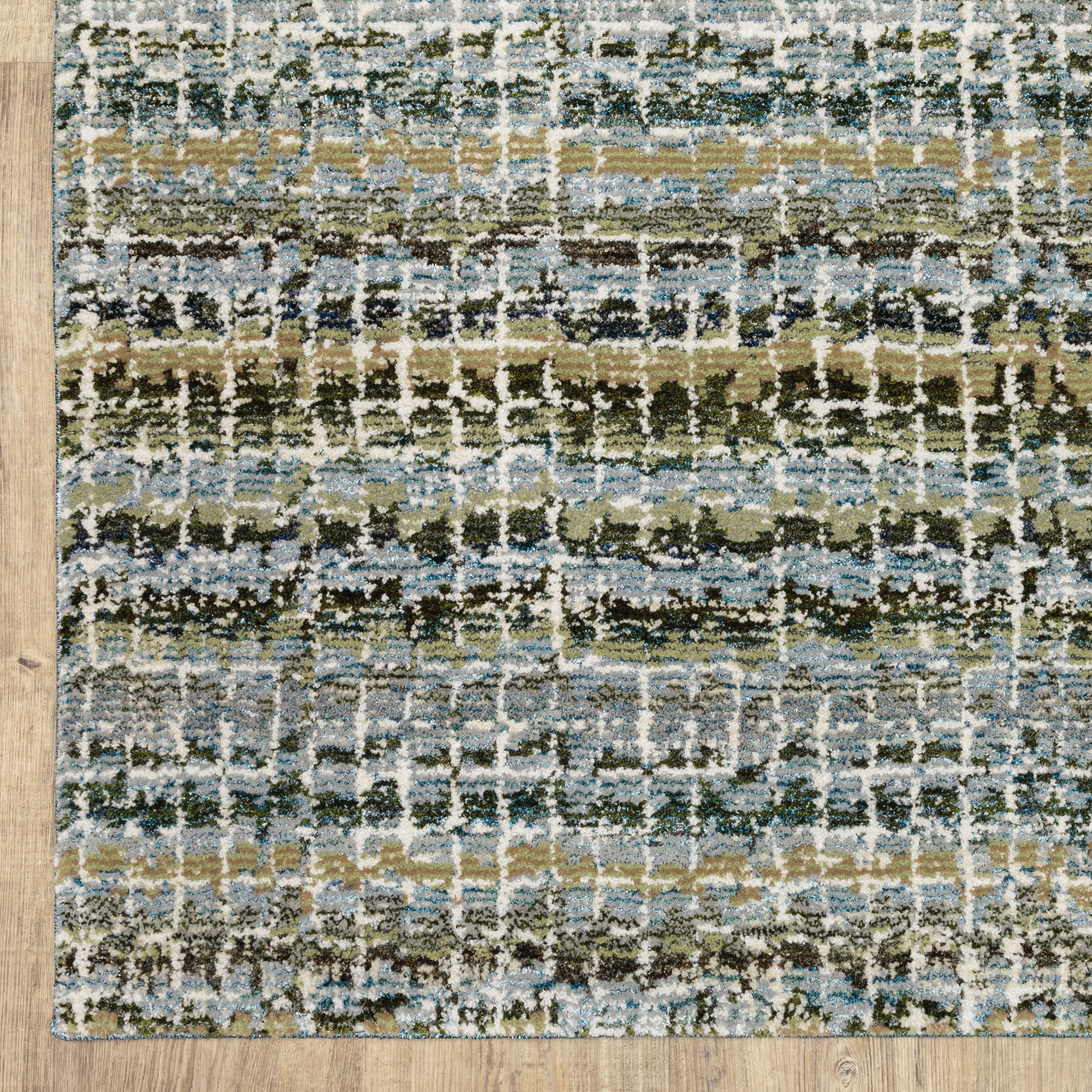 Oriental Weavers Atlas 747B0 textured area rug featuring textured design in blue/ green tones
