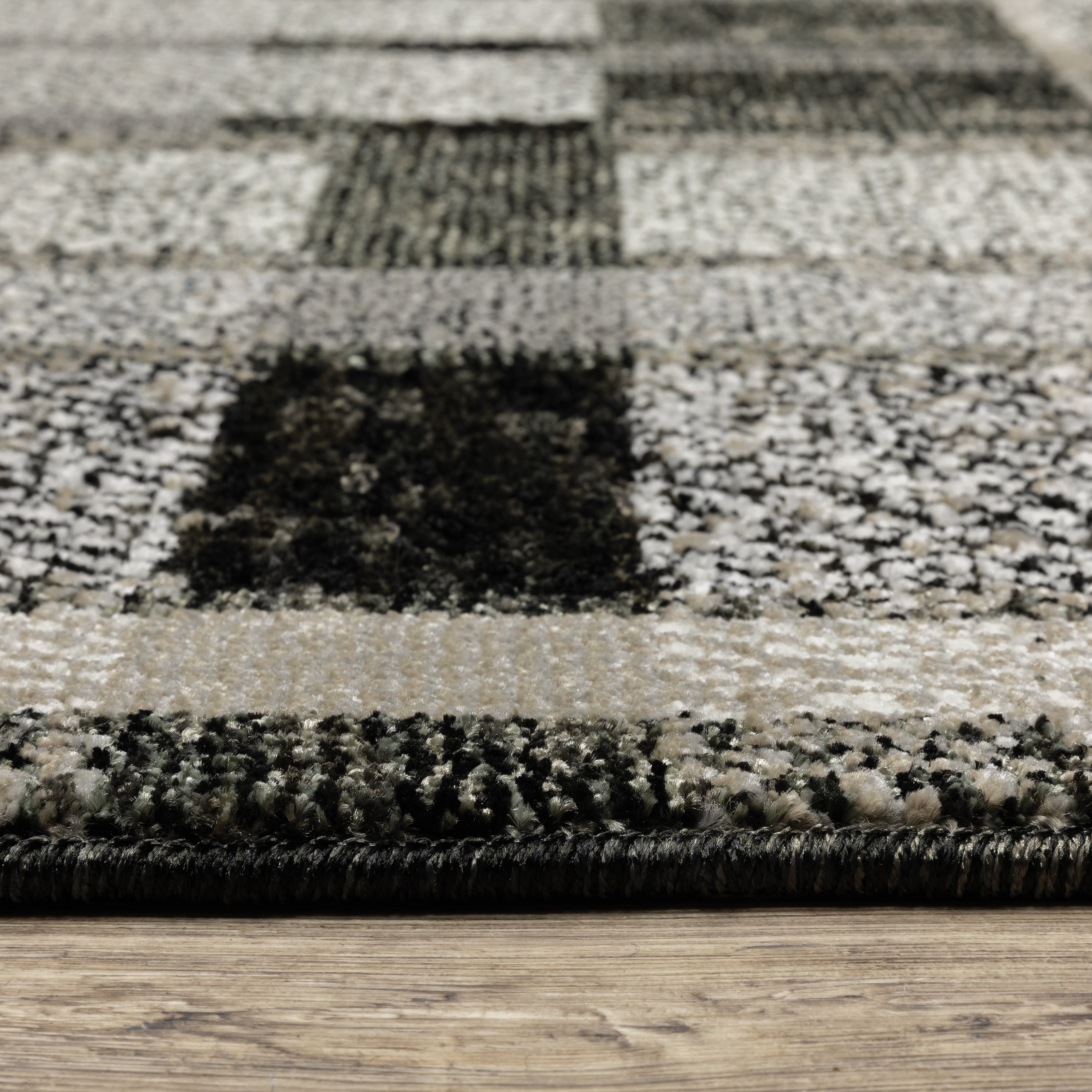 Oriental Weavers Atlas 752C0 textured area rug featuring textured design in black/ grey tones