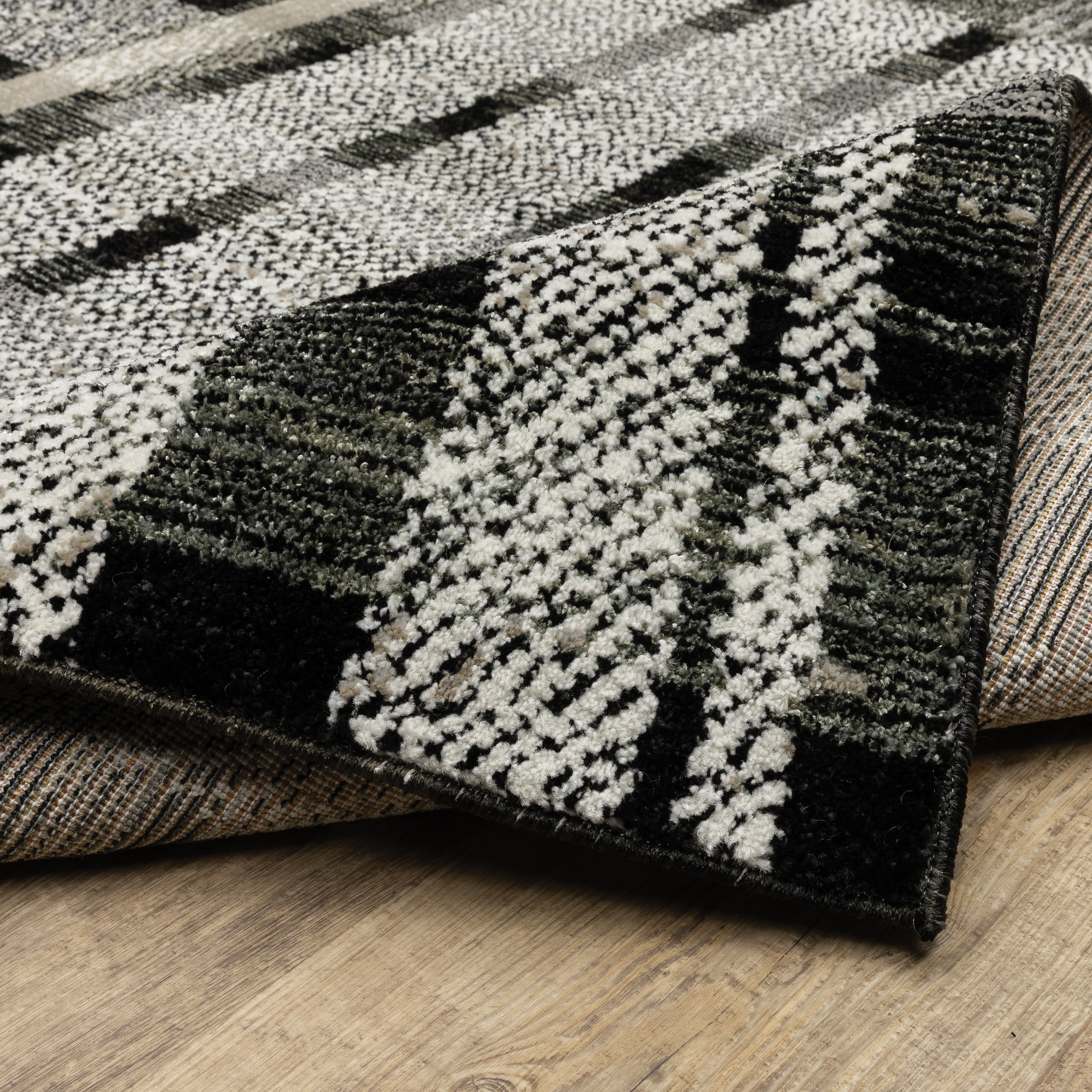 Oriental Weavers Atlas 752C0 textured area rug featuring textured design in black/ grey tones