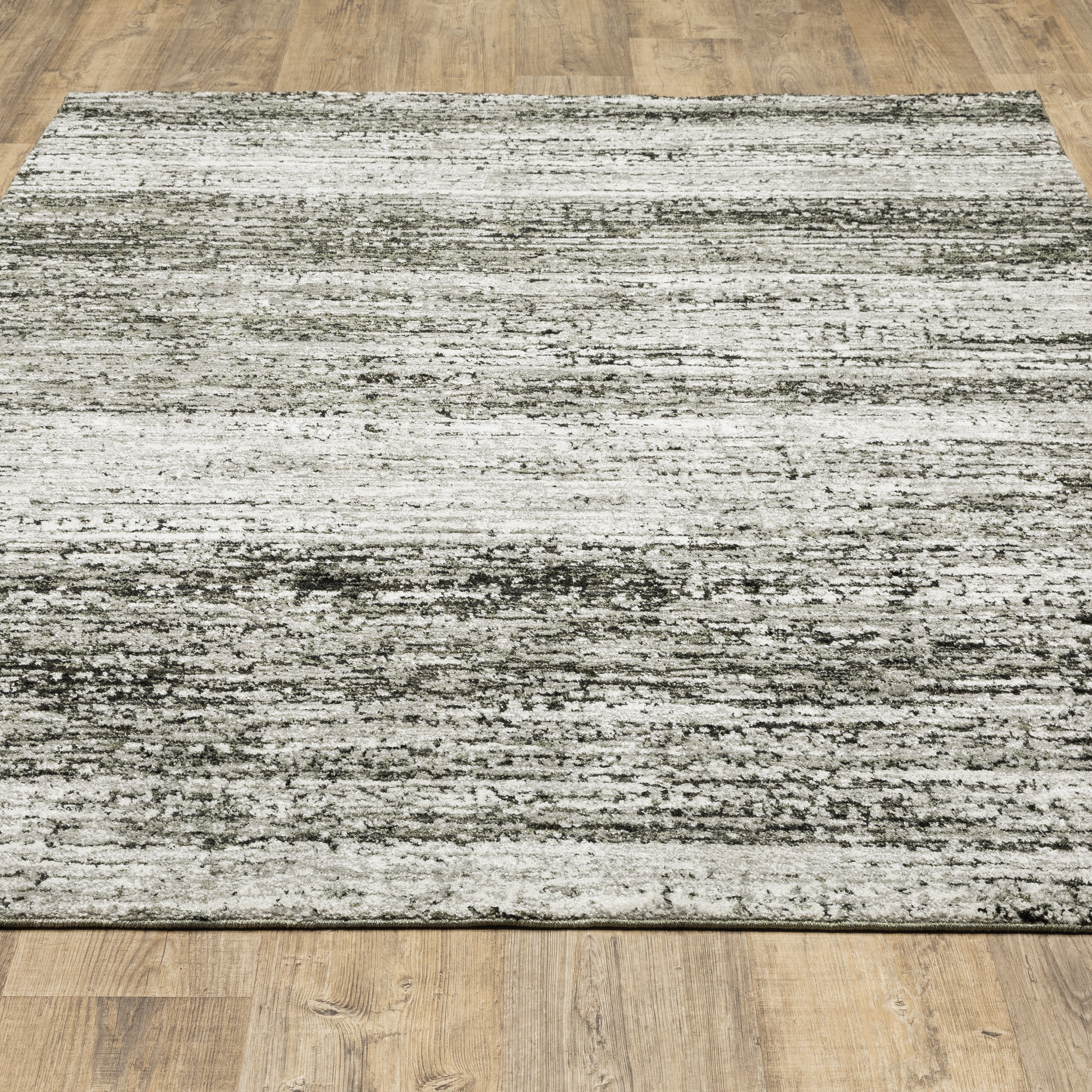 Oriental Weavers Atlas 8037G textured area rug featuring textured design in ash/ charcoal tones