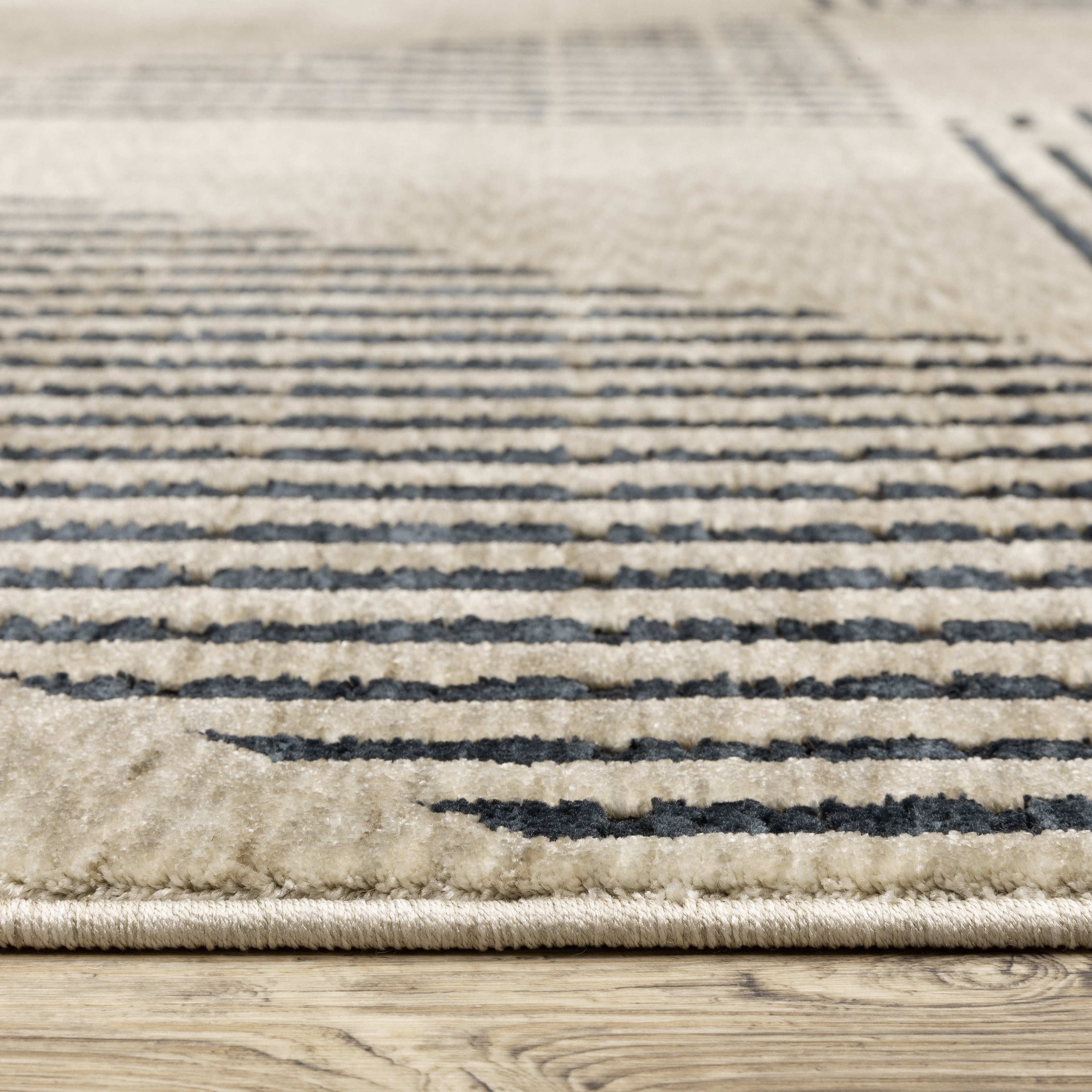Oriental Weavers Capella CAP04 soft transitional rug featuring textured design in beige/ deep navy tones