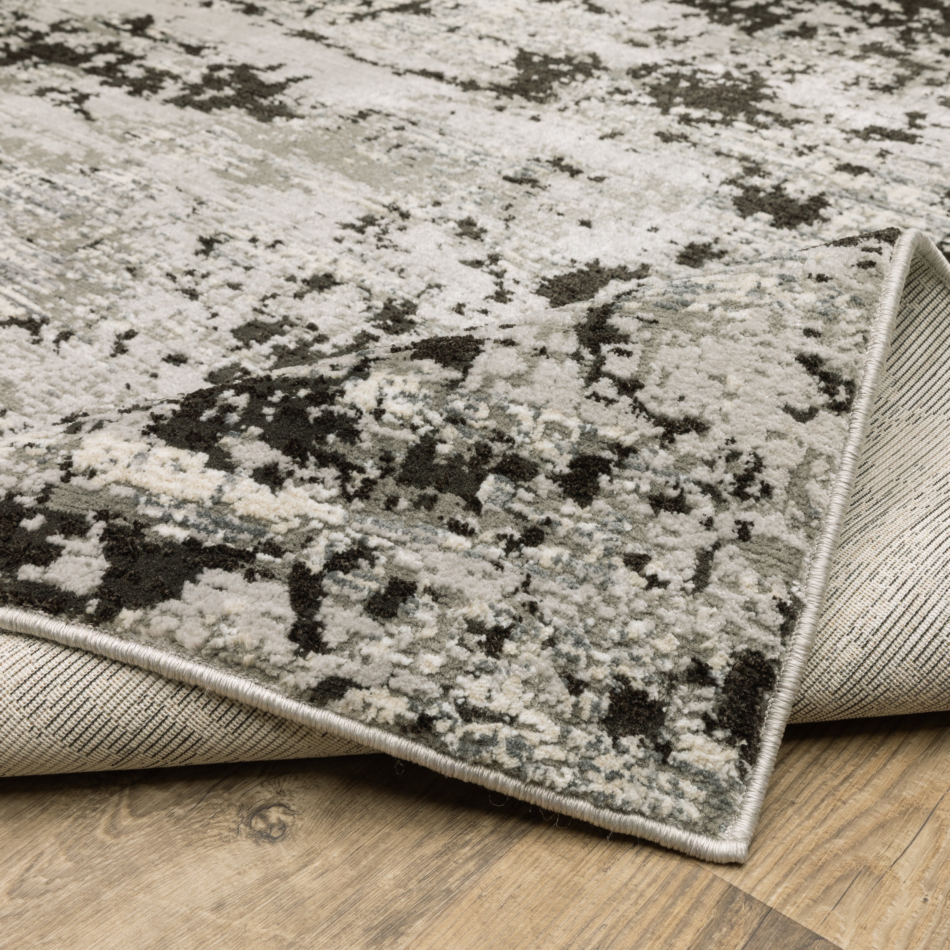 Oriental Weavers Caravan 4153Q soft area rug featuring textured design in grey/ black tones