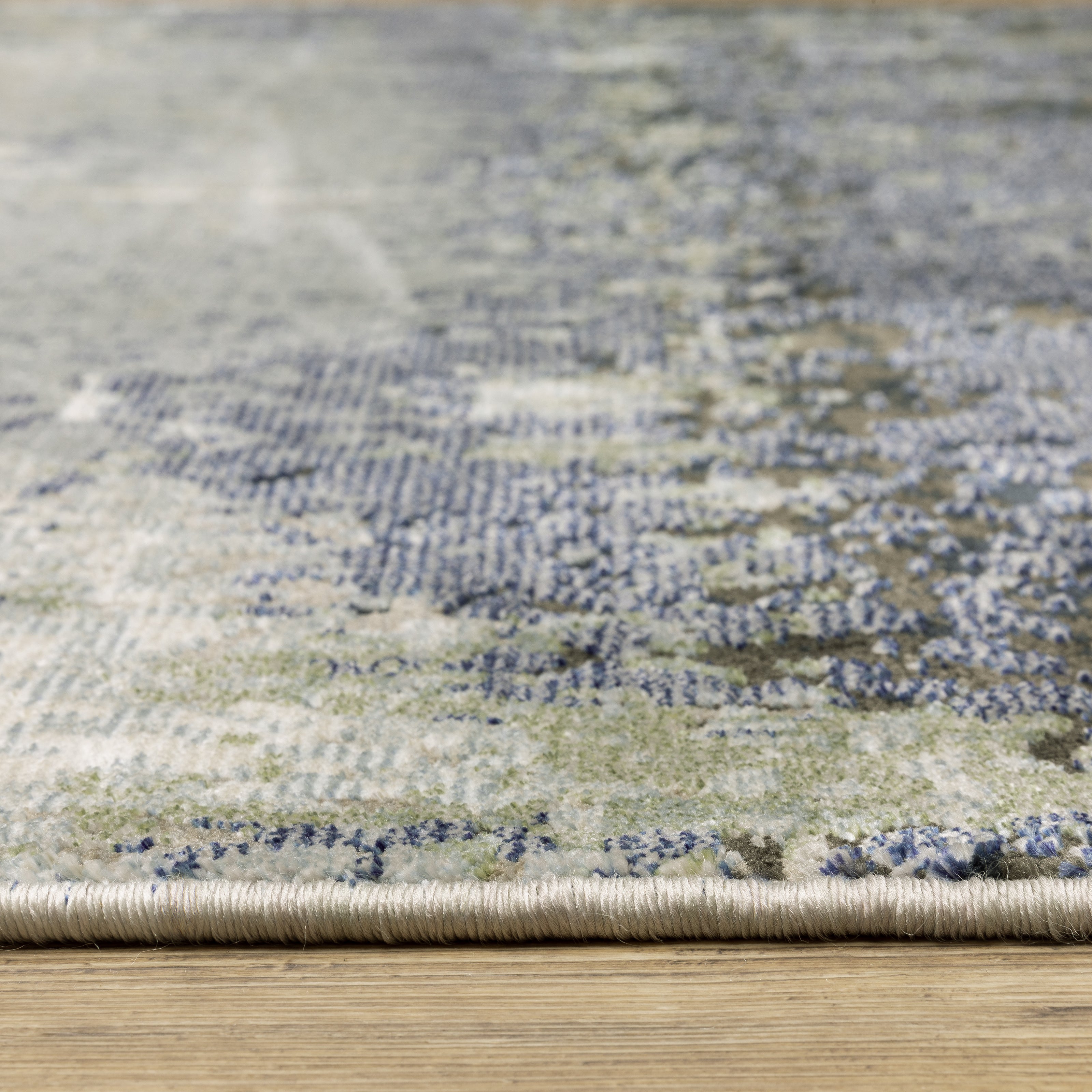 Oriental Weavers Caravan 5571H soft area rug featuring textured design in blue/ green tones