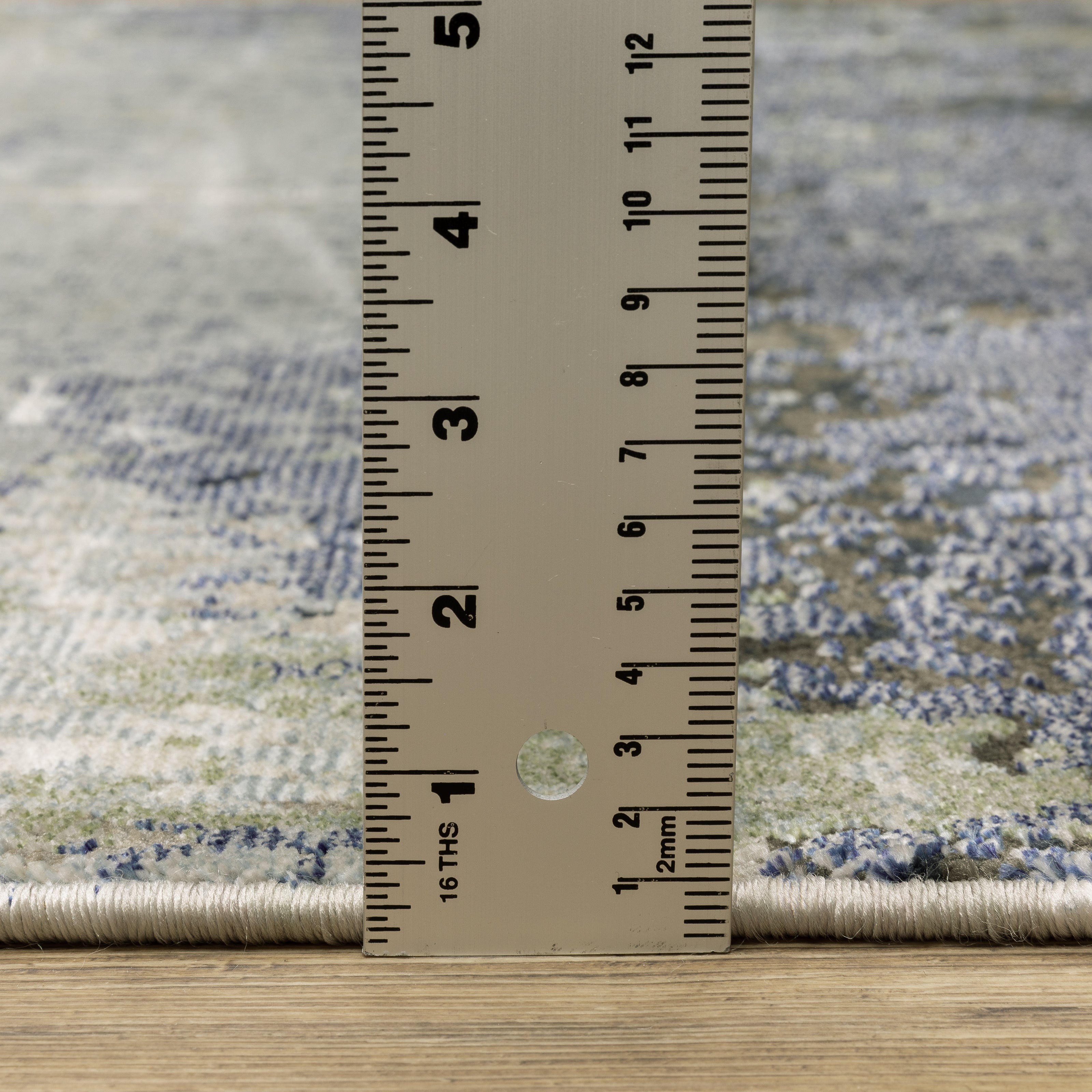 Oriental Weavers Caravan 5571H soft area rug featuring textured design in blue/ green tones