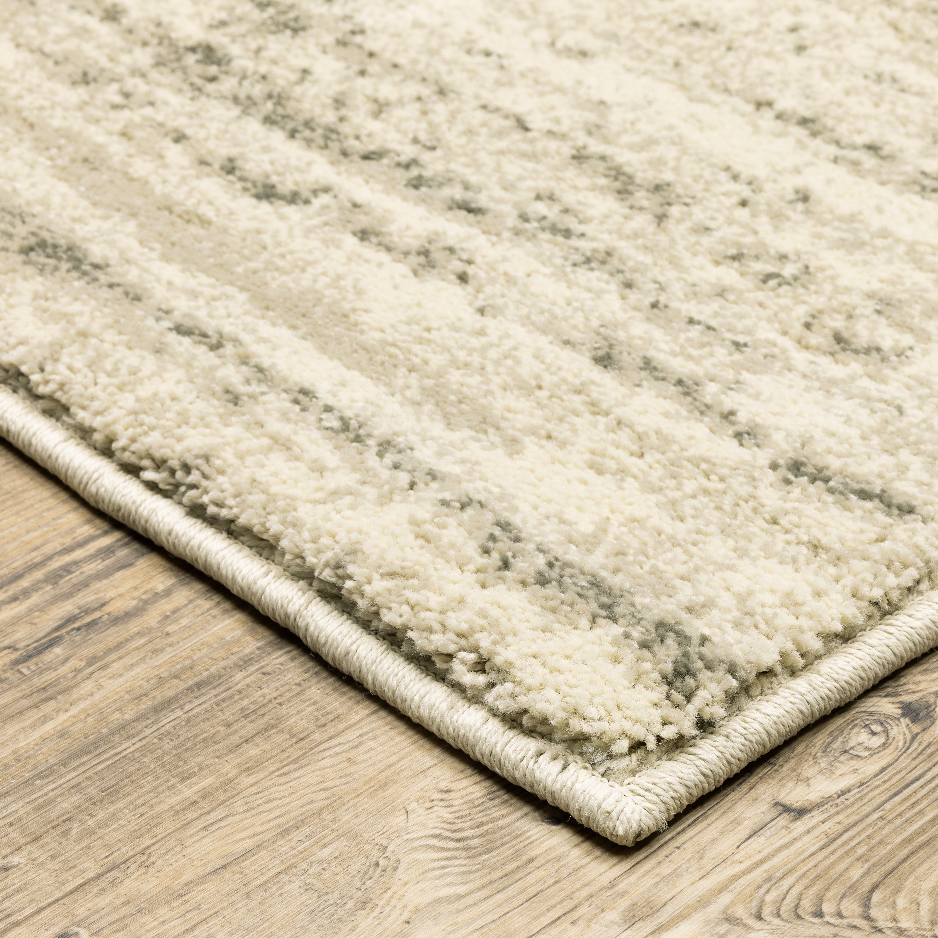 Oriental Weavers Carson 0735A plush modern rug featuring abstract pattern in beige/ grey tones
