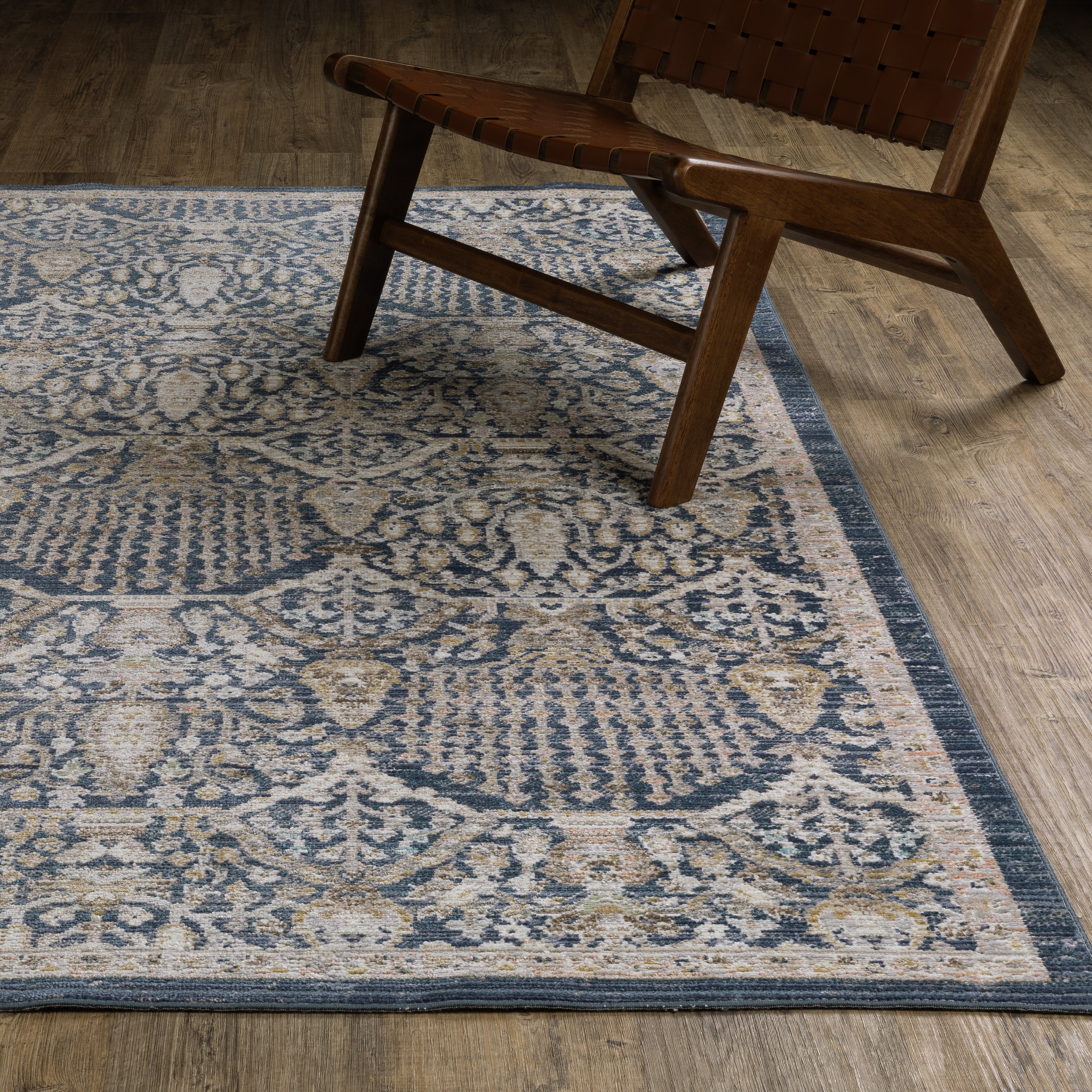 Oriental Weavers Cavett CAV06 soft transitional rug featuring decorative pattern in navy/ gold tones