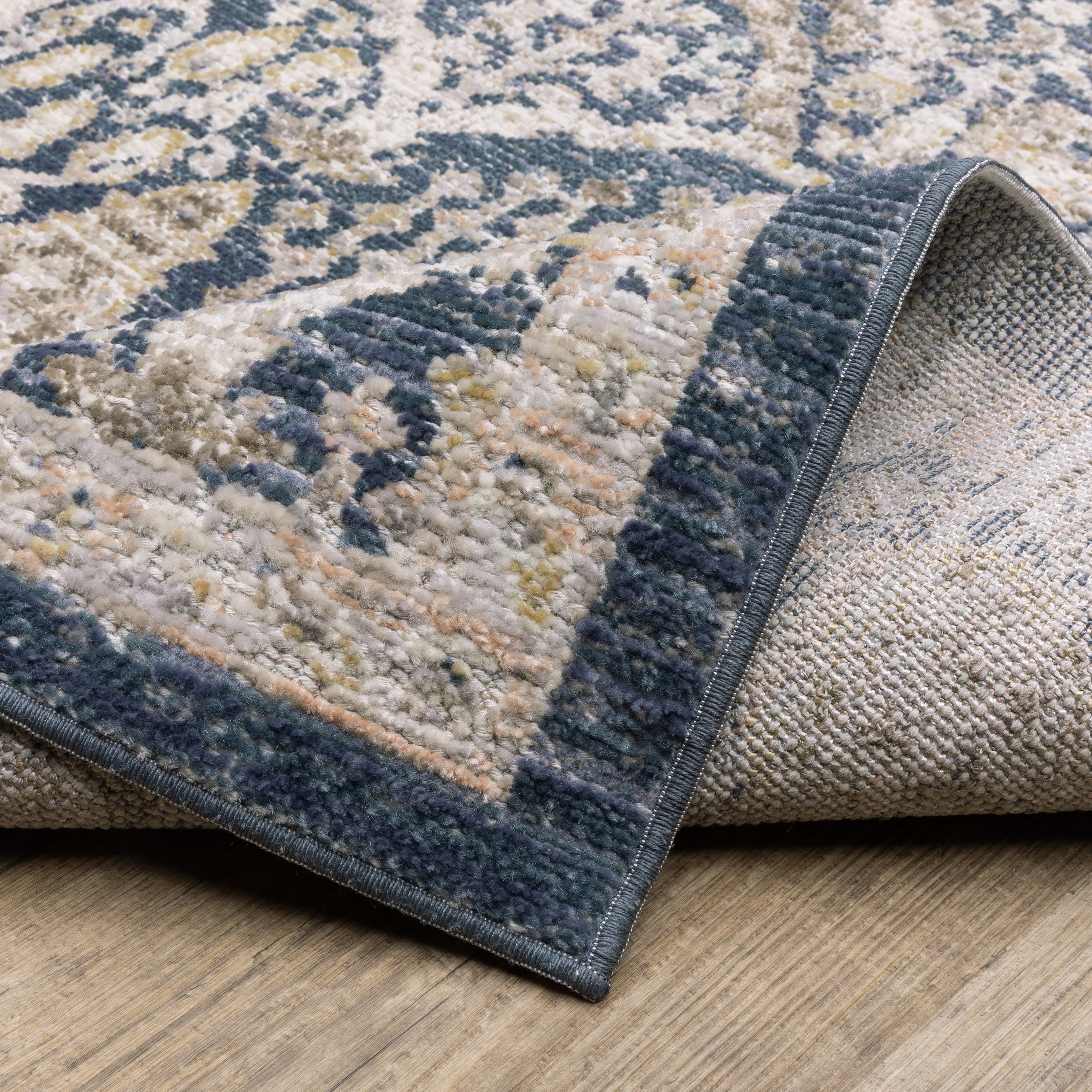Oriental Weavers Cavett CAV06 soft transitional rug featuring decorative pattern in navy/ gold tones