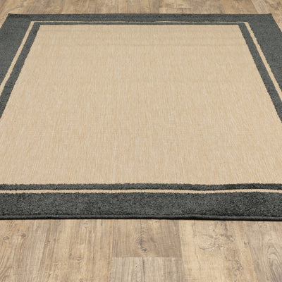 Oriental Weavers Cayman 5594K textured indoor-outdoor rug featuring abstract pattern in sand/ charcoal tones