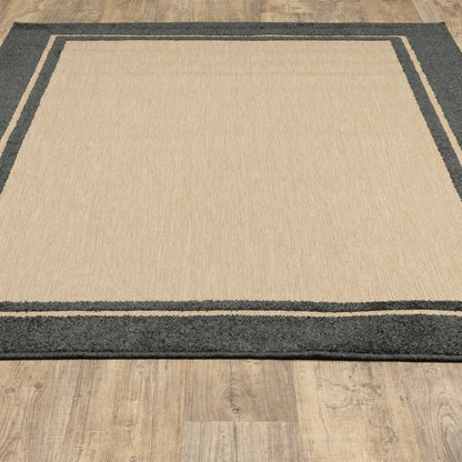 Oriental Weavers Cayman 5594K textured indoor-outdoor rug featuring abstract pattern in sand/ charcoal tones