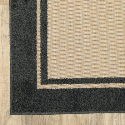 Oriental Weavers Cayman 5594K textured indoor-outdoor rug featuring abstract pattern in sand/ charcoal tones