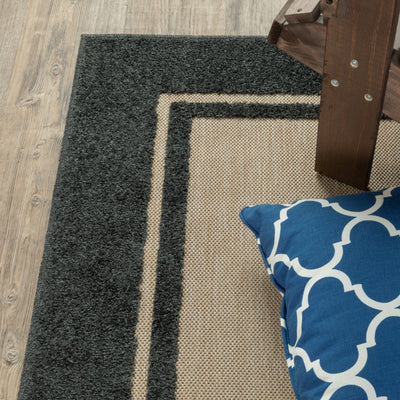 Oriental Weavers Cayman 5594K textured indoor-outdoor rug featuring abstract pattern in sand/ charcoal tones