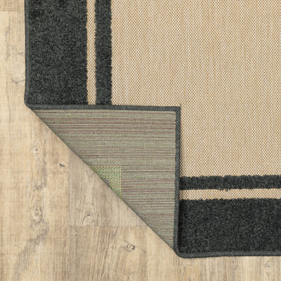Oriental Weavers Cayman 5594K textured indoor-outdoor rug featuring abstract pattern in sand/ charcoal tones