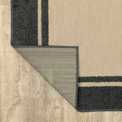 Oriental Weavers Cayman 5594K textured indoor-outdoor rug featuring abstract pattern in sand/ charcoal tones