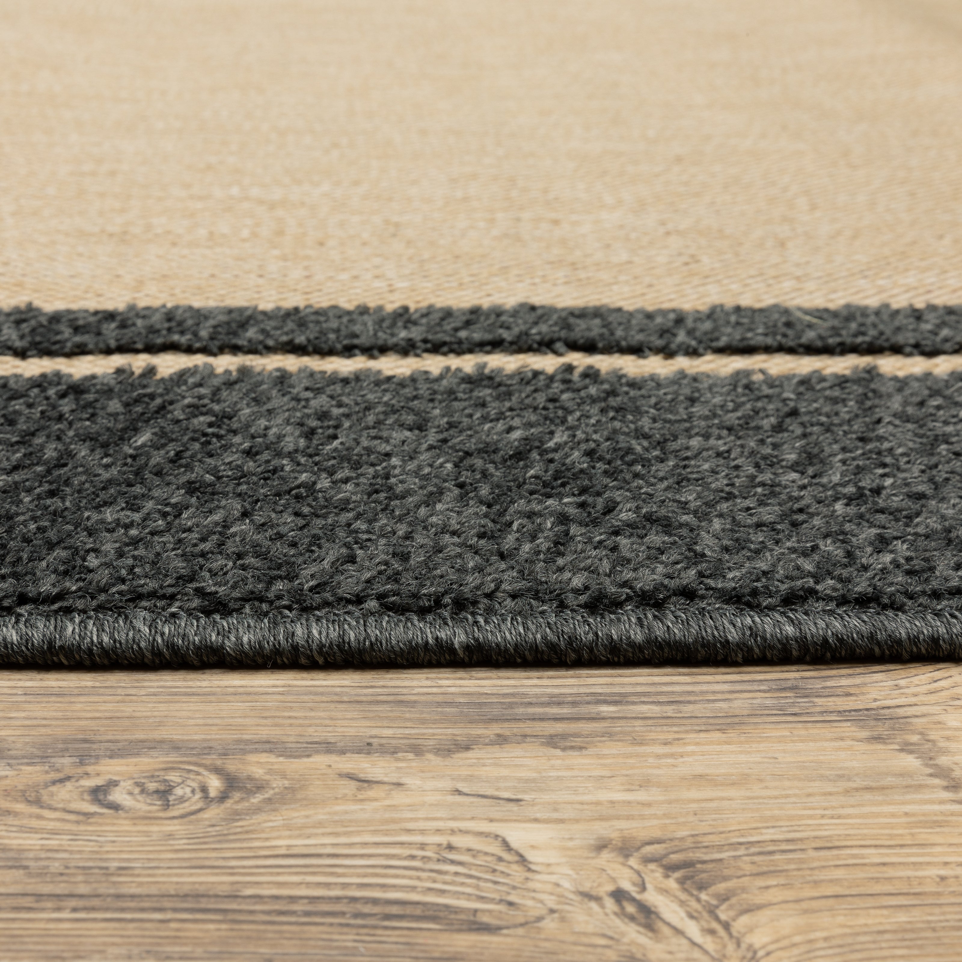 Oriental Weavers Cayman 5594K textured indoor-outdoor rug featuring abstract pattern in sand/ charcoal tones