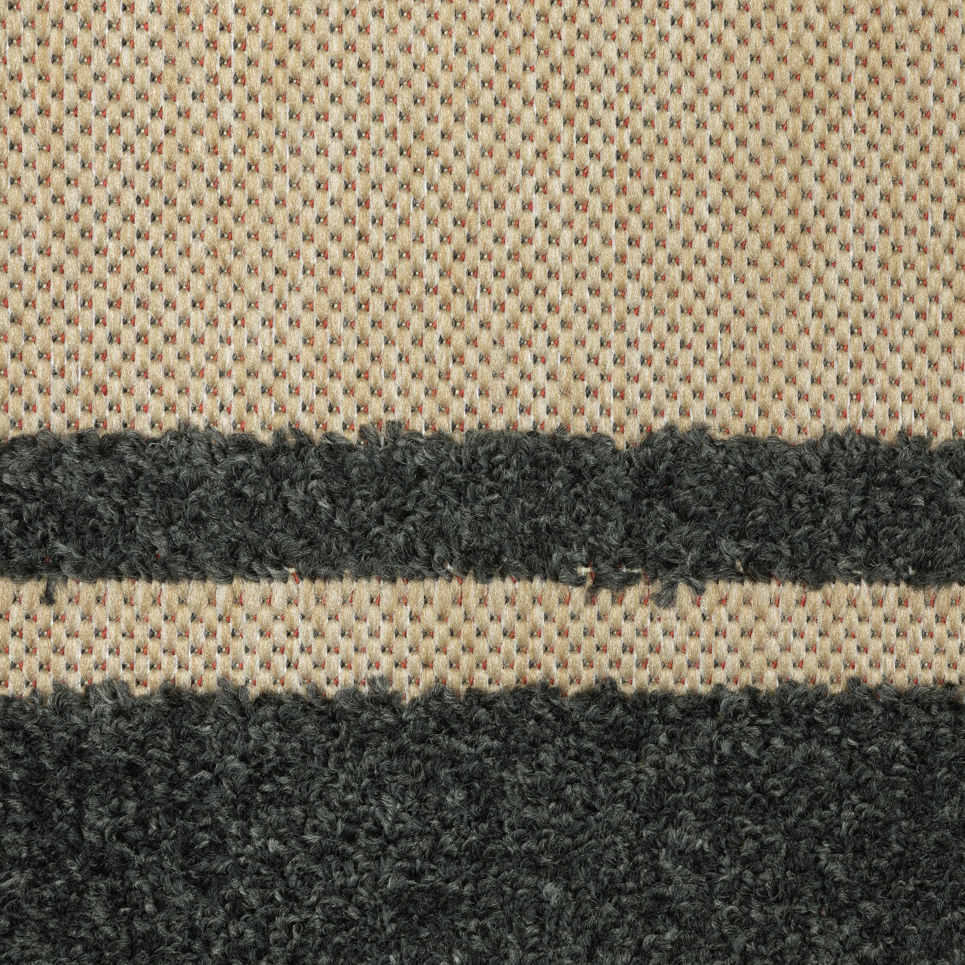 Oriental Weavers Cayman 5594K textured indoor-outdoor rug featuring abstract pattern in sand/ charcoal tones
