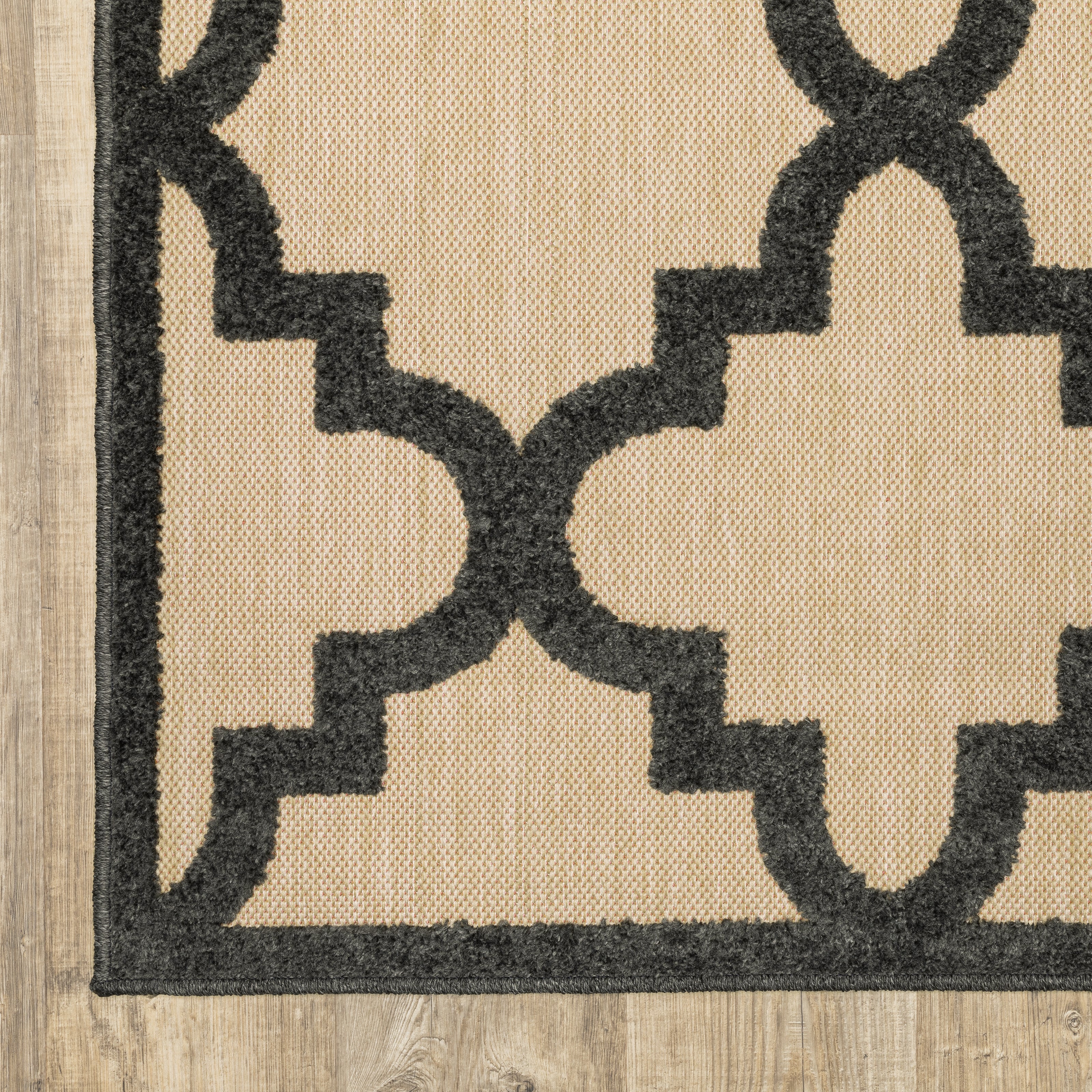 Oriental Weavers Cayman 660N9 textured indoor-outdoor rug featuring abstract pattern in sand/ charcoal tones