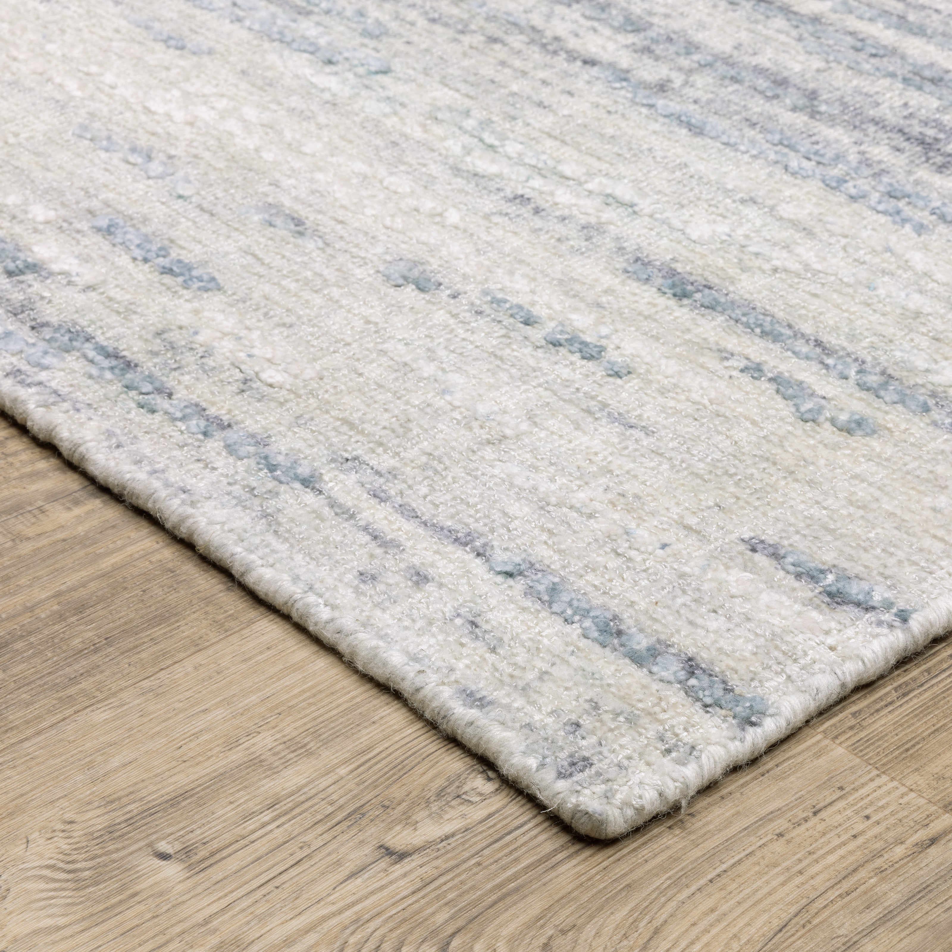 Oriental Weavers Clarke CLA04 soft modern rug featuring abstract pattern in ivory/ blue tones