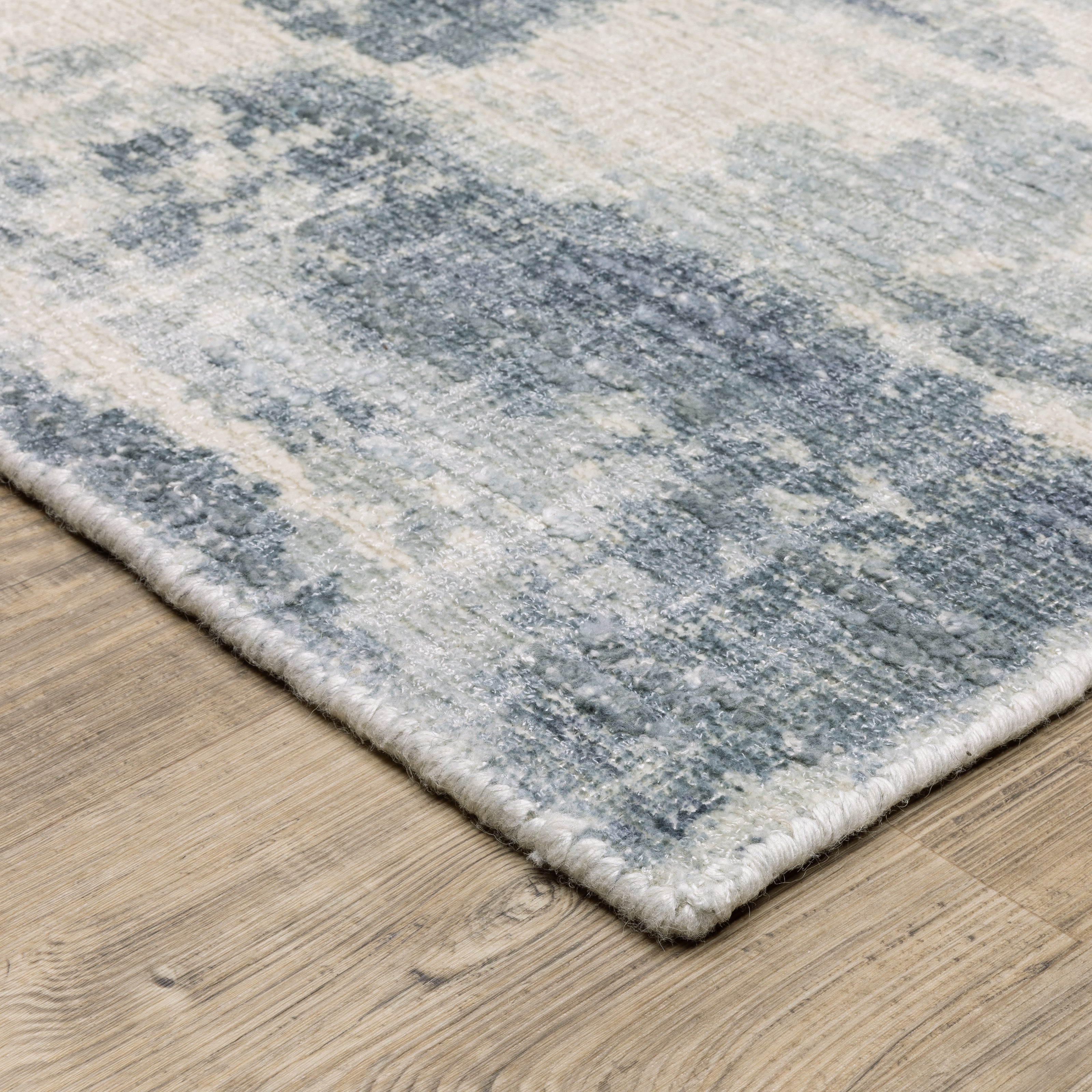 Oriental Weavers Clarke CLA07 soft modern rug featuring abstract pattern in blue/ ivory tones