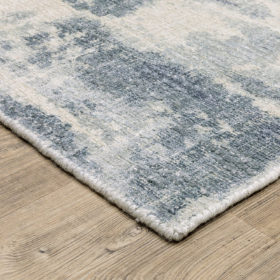 Oriental Weavers Clarke CLA07 soft modern rug featuring abstract pattern in blue/ ivory tones